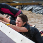 A woman hangs onto block in water