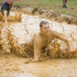 Participant swimming in the mud