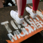 fabletics white trainers on tough mudder obstacle