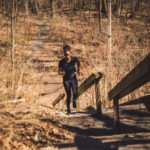 woman running up steps on trails